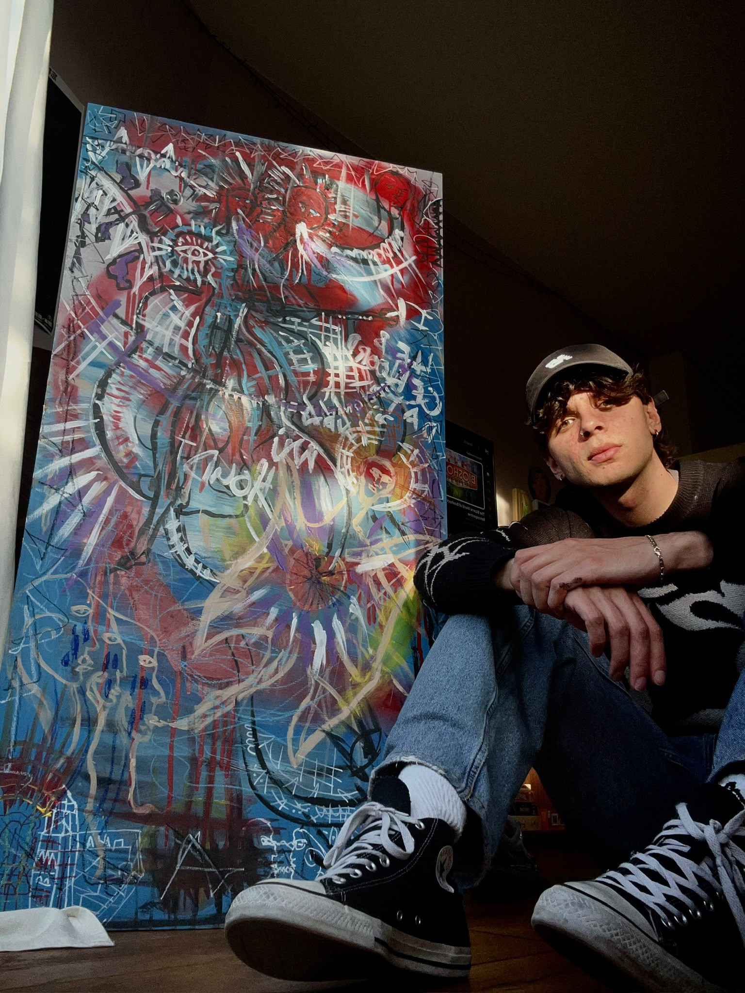 Chet Lonely Hearts with one of his paintings